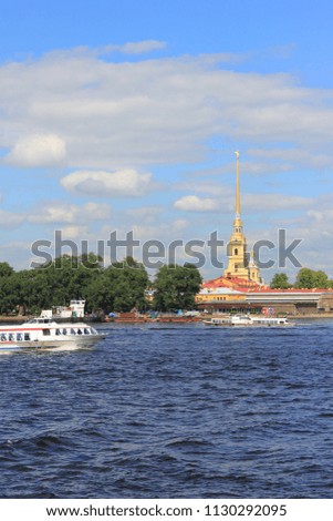 St. Petersburg Cityscape with Peter and Paul Fortress on Hare Island in Russia. Saint Petersburg Colorful Summer Scene, Skyline View from Neva River Water with Tourist Sightseeing Cruise Boat.
