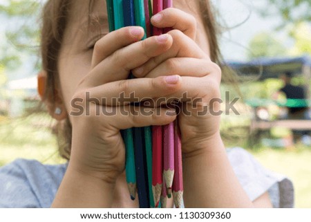 the child holds colorful pens for school activity time or education concept.creative ideas for child development.