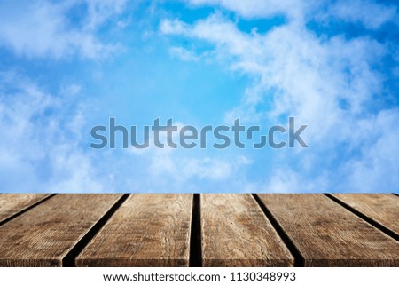 Wood table top on sky background - can be used for display or montague your products.Mock up for display of product.