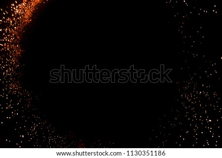 Abstract colored golden firework isolated on a black background with free space for text.  Concept of Christmas and New Year holidays. Bengal lights, glitter and sparks. 