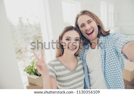Mortgage relocation package new life large big loft window rent good day event concept. Close up picture glad cheerful emotional satisfied nice beautiful married couple making selfie against havings