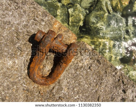 Rusty chain cleat on concrete mall