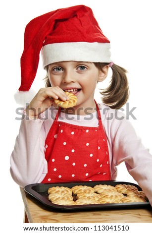little girl eating Christmas cookies - white background