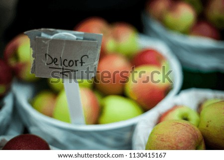 Basket of apples at farmer's market, with label in focus