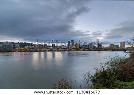 Portland Oregon downtown city skyline and Hawthorne Bridge over Willamette River waterfront during evening
