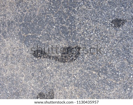A wet footprint outside on the concrete 