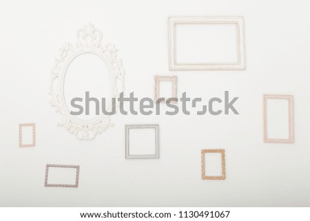 White wall with different photo frames