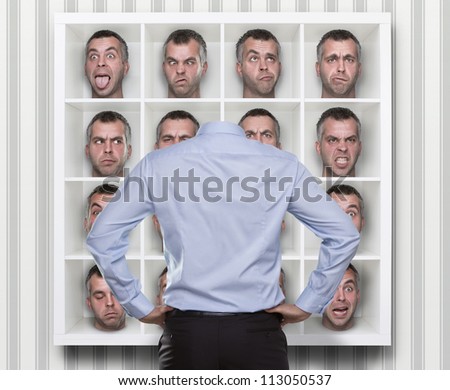 Confused conceptual image, young businessman choosing which face expression to wear