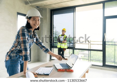 woman civil architect engineer discuss or brain stroming work with collegue ,engineering and architecture concept.Blue print is fake only for stock photo.