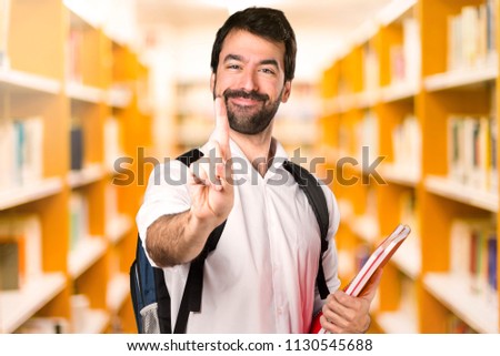 Student man counting one on defocused library