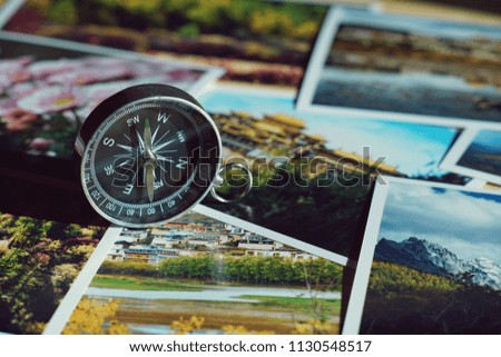 Compass on blur colorful photograph of popular toustist destination background, China traveling concept