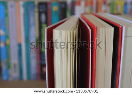 Close-up of books placed in the library the book on the shelves is the background selective focus and shallow depth of field