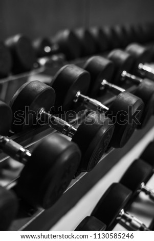 Dumbbells on a weight rack in GYM, Black and white tone.