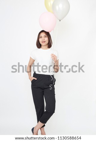 Attractive young asian woman with air balloons on white background