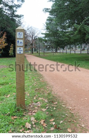 a signpost indicating a shared footpath and keep dogs on lead on a walking track
