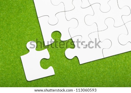 Jigsaw puzzle on green background