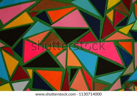colorful background made from colored paper pieces, art and craft on a green base