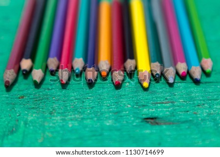 colorful pens on the green wooden table for school activity time or education concept.creative ideas for child development.