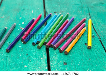 colorful pens on the green wooden table for school activity time or education concept.creative ideas for child development.