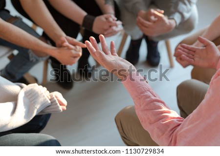 Close-up of therapist's hands explaining a problem to his patients Royalty-Free Stock Photo #1130729834