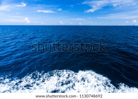 Blue Seawater with sea foam as background