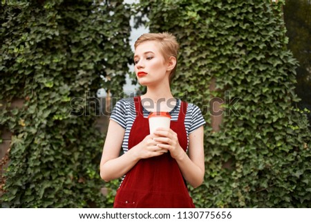  woman with coffee walking around the city                             