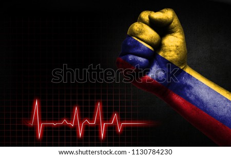 Flag of Colombia painted on male fist, the concept image shows the strength of medicine or politics in countries, photography has a good place for your text