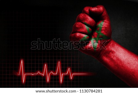 Flag of Morocco painted on male fist, the concept image shows the strength of medicine or politics in countries, photography has a good place for your text
