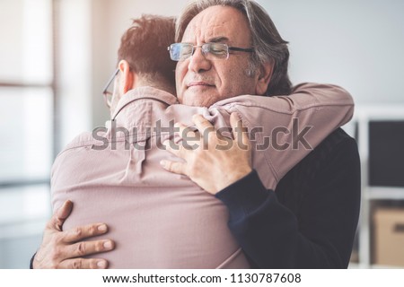 Son hugs his own father Royalty-Free Stock Photo #1130787608