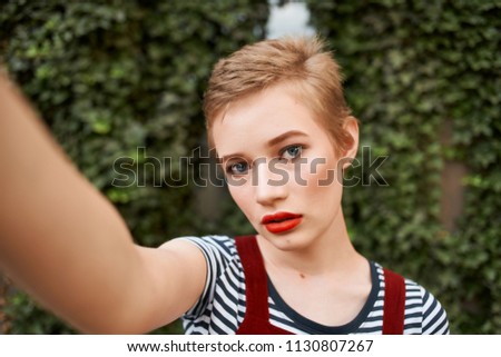 woman photographing herself street selfie                               