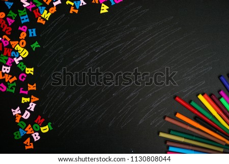 Back to school background. Top view of school supplies on chalkboard