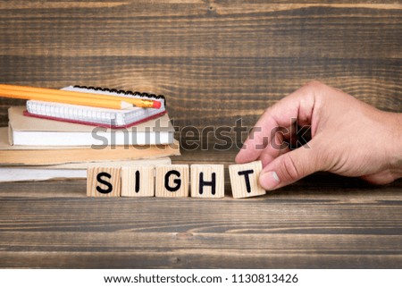 Sight. Wooden letters on the office desk, informative and communication background