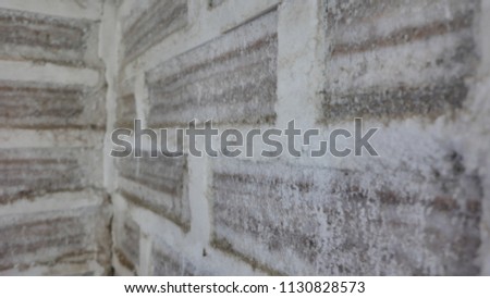 Wall background texture made of salt bricks blocks near the Salar de Uyuni, Bolivia. Salt is a natural ionizer and create a bacteria free environment. It has cozy and relaxing brown and white colors.