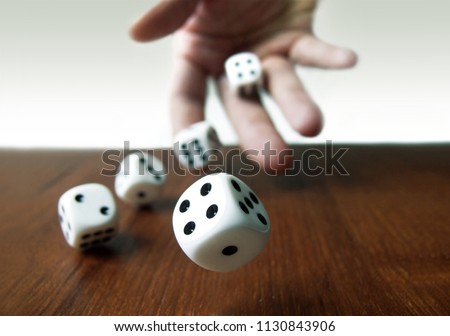 Hand & Rolling Dices  Royalty-Free Stock Photo #1130843906
