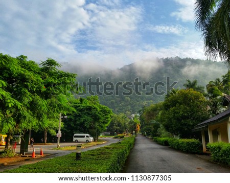 Scenery of mountain with blue sky and fog.