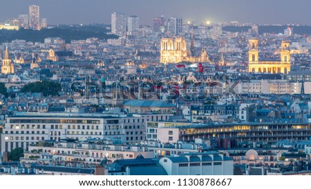 Aerial panorama above houses rooftops in a Paris day to night transition timelapse. Evening view Notre Dame de Paris and Saint-Sulpice illuminated after sunset