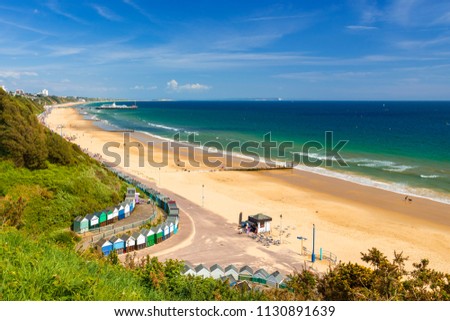 Sunshine illuminates golden beaches and blue-green seas along the Dorset coast at Middle Chine between Poole and Bournemouth