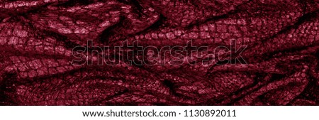 Red silk fabric. Texture, background, pattern. It has a fine luster with small color variations to give the appearance of slabs in the fabric. Ideal for adding a touch of luxury to your decor
