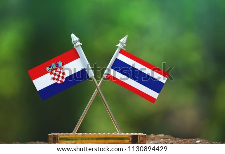 Thailand and Croatia small flag with blur green background