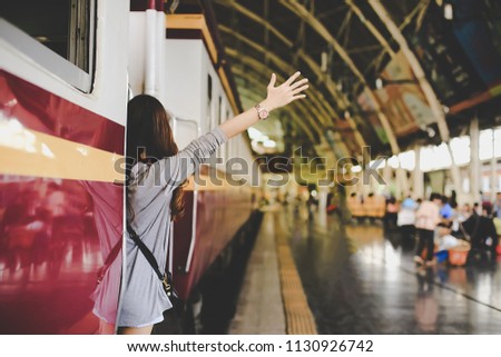 Enjoying travel. Asian women travel relax in the holiday.She was happily waving goodbye to her friend.