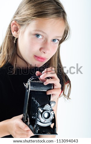 portrait of a girl holding an old camera