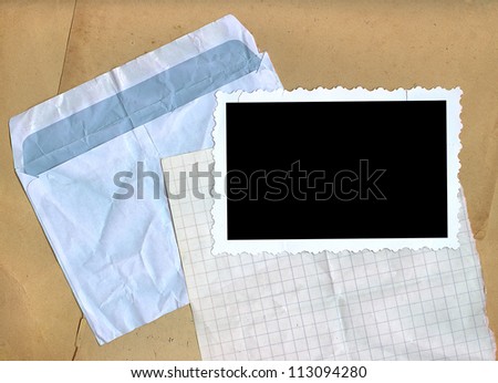 Crumpled envelope, squared paper, photo edges.
