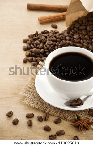 cup of coffee with beans and ingredient at wooden texture