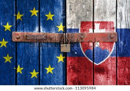 European Union flag with the Slovakia flag on the background of old locked doors