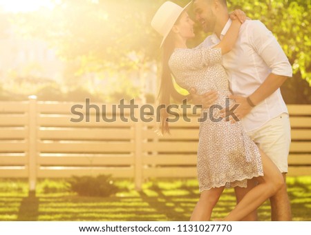 couple in love at sunset walking in the park happy, American dream. The concept of family values.