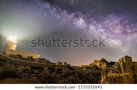 Night long exposure astrophotography. Milky Way over Cavalleria lighthouse, Menorca, Balearic Islands, Spain