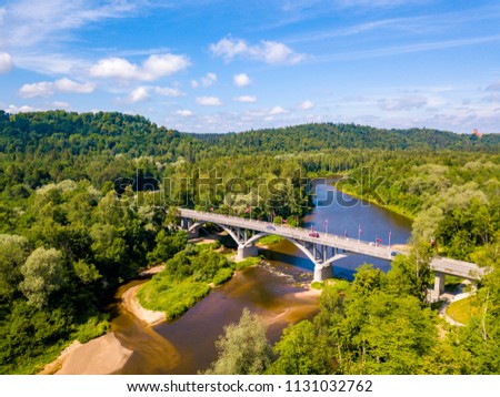 Aerial view of the Sigulda city with Gauja river and a bridge across it with cable car over the valley