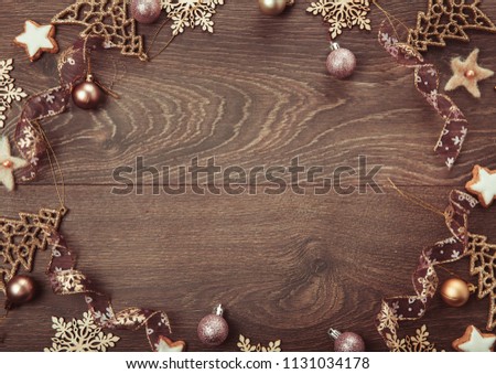 Christmas holiday composition, ornament. Festive creative gold pattern, spruce branches, xmas tree, xmas golden decor holiday ball with gift and ribbon on wooden brown background. Flat lay, top view