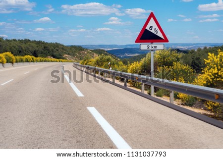 Warning road sign slope.