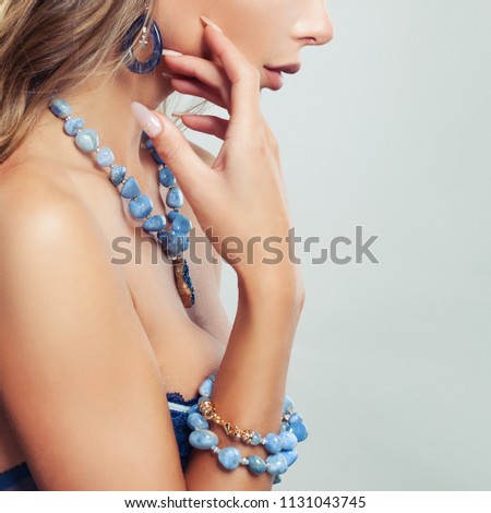Female body with jewelry necklace, bracelet and earrings with blue gem